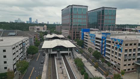 Aerial-view-of-Lindbergh-Marta-Station-with-office-Buildings-and-skyline-in-Background---Atlanta,-Georgia
