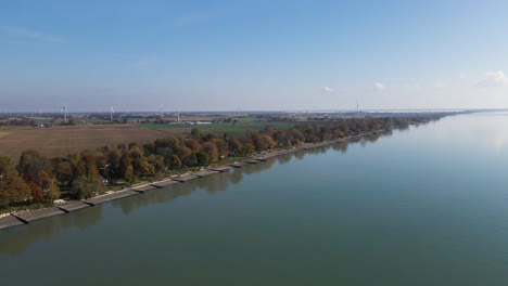 Panoramic-aerial-overview-of-Blenheim-Lake-Erie-coastal-township-with-wind-turbines-and-fields
