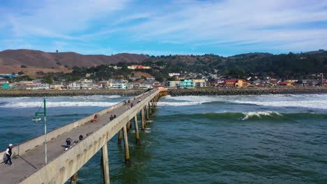 Aerial-view-flying-along-the-Municipal-Pier,-toward-the-Pacifica-city-in-CA,-USA
