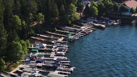 a-lot-of-boats-parked-at-boat-docks-on-lake-arrowhead-california-during-sunset-with-telephoto-compression-AERIAL-DOLLY