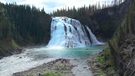 Bride-walking-down-the-aisle-of-her-wedding-at-the-base-of-Kinuseo-waterfalls-in-Alberta-Canada