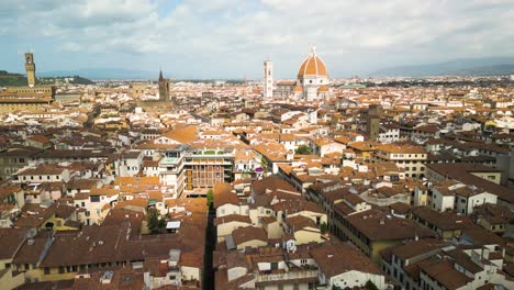 Cloud-shadows-hide-sunlight-on-top-of-brown-buildings-in-Florence-Italy