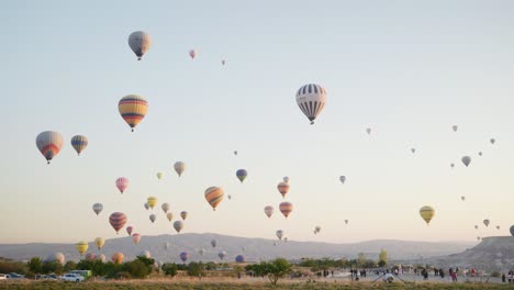 Sunrise-golden-hour-sky-filled-with-colourful-hot-air-balloons