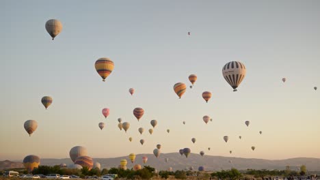 Sunrise-golden-hour-sky-filled-with-hot-air-balloons