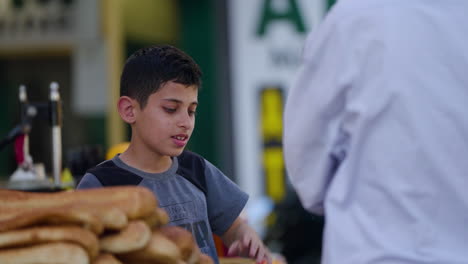 Kid-Selling-Bread-On-Street-Of-Jerusalem,-Israel