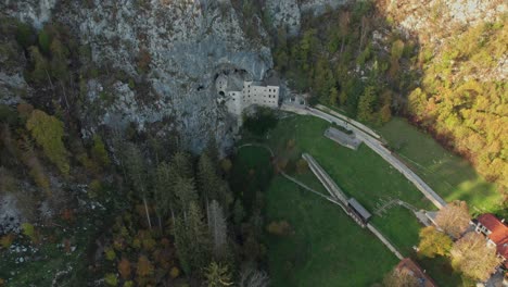 aerial-traveling-tilt-down-shot-of-Predjama-Castle,-Slovenia