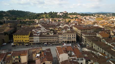 Drone-orbits-around-courtyard-of-Basilica-of-Santa-Croce-in-Florence-Italy-as-clouds-shade-the-buildings