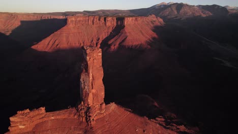 Gold-sunset-shadow-aerial-orbits-Castleton-Tower-rock-spire-near-Moab