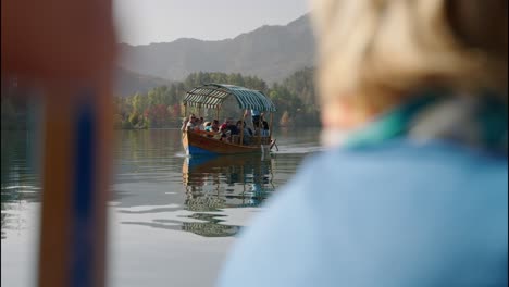 slowmo-with-selective-focus-on-boat-with-tourist-on-board-sailing-lake-bled-in-slovenia-on-a-sunny-day