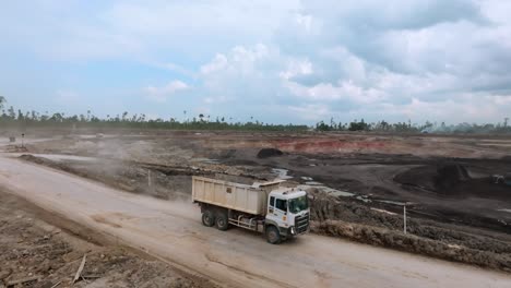 Dump-Trucks-Driving-To-The-Coal-Mine---Coal-Surface-Mining-Site-In-Berau,-Indonesia