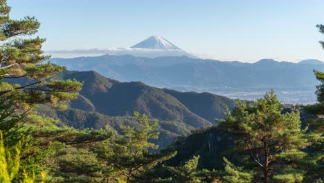 Panoramic-view-of-Mount-Fuji-behind-mountains-in-nature---Timelapse