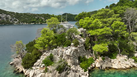 Drone-dolley-shot-over-the-rocks-of-Mljet-Island-with-luxury-yatchs-moored-in-the-bay