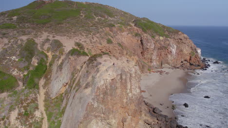 Orbiting-Shot-of-Couple-on-Beach-Cliff---Point-Dume
