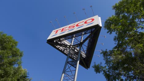 Tesco-banner,-logo-of-British-shopping-mall-with-the-blue-sky