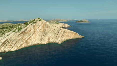 Slowly-drone-dolley-shot-of-the-high-cliffs-of-Kornati-national-Park-on-a-sunny-day