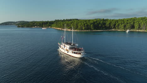 Drone-following-shot-of-the-Korcula-tour-boat-during-golden-hour-in-Croatia