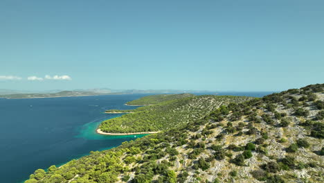 Calm-drone-dolley-shot-over-Zmajan-island-coast-line-in-Croatia-on-sunny-summer-day