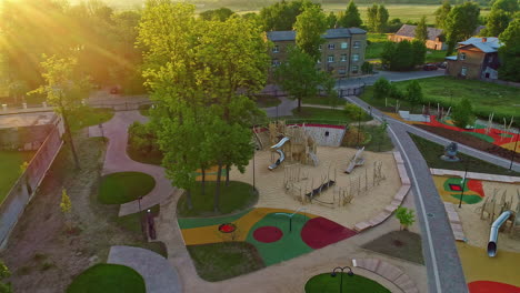 Cozy-colorful-town-park-and-kids-playground,-aerial-drone-view