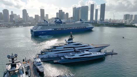 Aerial-drone-video-of-Miami-International-Boat-Show-with-a-large-passenger-ship-in-the-background