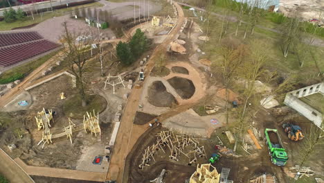 Workers-renovating-park-in-Europe-city,-aerial-drone-view