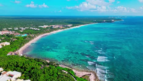 Tulum-Mexico-drone-view-of-the-beach-with-large-waves-crashing-on-the-rocky-shore