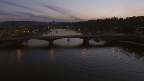 Flying-over-Prague-Manes-Bridge-view-in-the-dusk