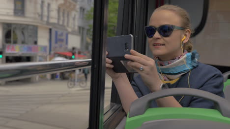 Woman-in-double-decker-bus-enjoying-city-tour