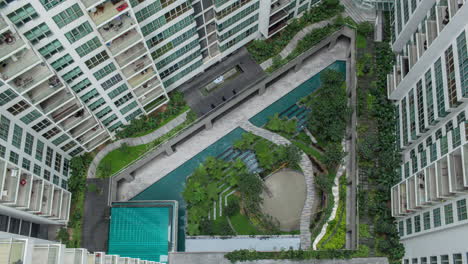 Aerial-timelapse-of-people-in-decorative-garden-outside-apartment-blocks