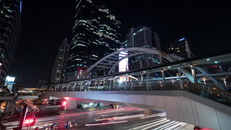 Timelapse-of-busy-road-and-pedestrian-overpass-in-night-Bangkok