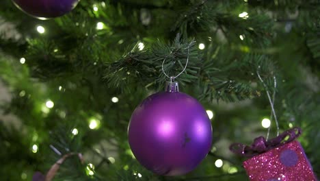 Hanging-purple-ball-for-decoration-in-the-christmas-tree-with-led-lights-in-the-living-room-during-the-holidays