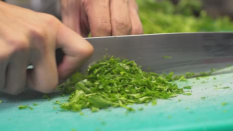 Close-up-on-cook's-hands-cutting-parsley-SLOWMOTION-100fps