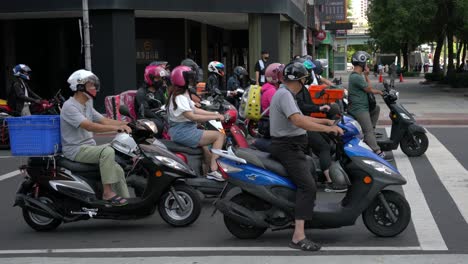 Motorcyclists-waiting-patiently-at-the-traffic-junction-in-Taipei,-Taiwan