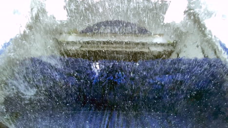An-automatic-drive-through-car-wash-operating-and-seen-from-inside-a-vehicle