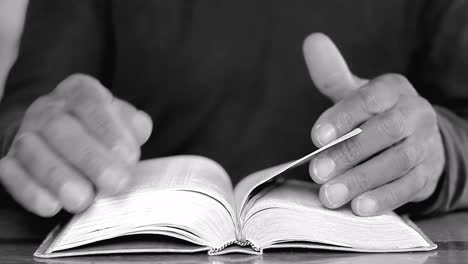 praying-to-God-with-hands-on-bible-on-table-with-people-stock-footage-stock-video