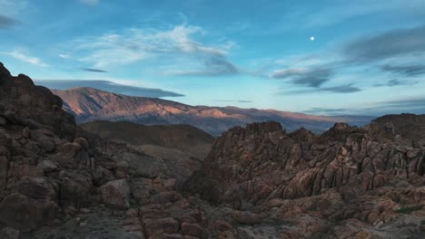Sunset-with-a-moon-over-the-rocks-of-the-iconic-Alabama-Hills