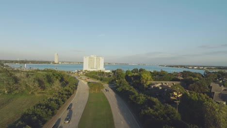 An-aerial-establishing-shot-of-the-Hilton-Hotel-overlooking-Clear-Lake-and-Endeavor-Tower-at-sunset-on-NASA-Rd-1-in-Clear-Lake,-Houston,-Texas