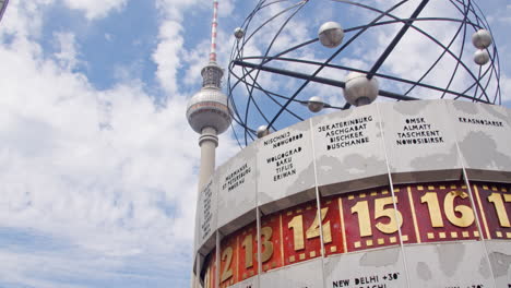 High-resolution-video-of-Berlin's-TV-Tower-at-Alexanderplatz-on-a-sunny-yet-cloudy-day,-featuring-the-World-Time-Clock,-capturing-the-essence-of-Berlin,-Germany