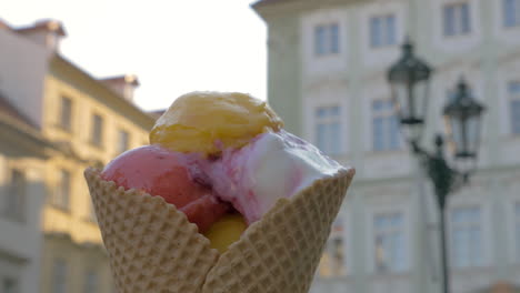 Appetizing-waffle-cone-ice-cream-on-street-background