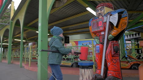 Slow-motion-view-of-small-boy-hitting-with-toy-hammer-game-in-amusement-park-Vienna-Austria