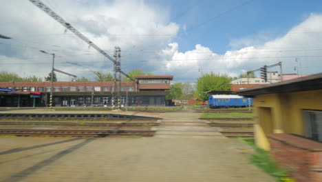 Vista-Desde-El-Tren-De-Pasajeros-Sobre-Las-Vías-Del-Ferrocarril-Y-Un-Tren-Que-Pasa