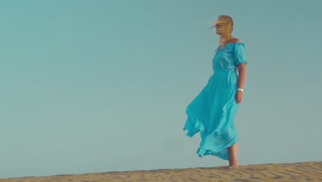Woman-in-blue-dress-on-the-beach