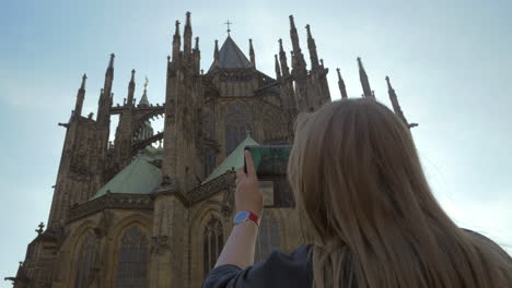 Woman-tourist-taking-mobile-photo-of-St-Vitus-Cathedral-Prague