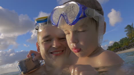 Slow-motion-view-of-happy-young-father-with-son-in-the-water-in-snorkeling-masks-Port-Louis-Mauritius-Island