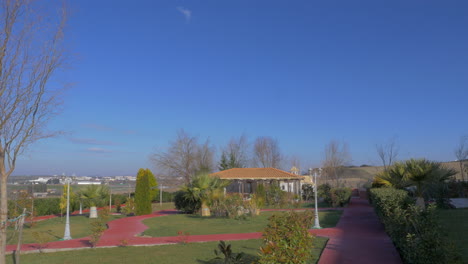 Malerische-Panoramalandschaft-Des-Parks-Mit-Tropischen-Bäumen,-Graspavillon-Und-In-Nea-Kallikratia,-Griechenland