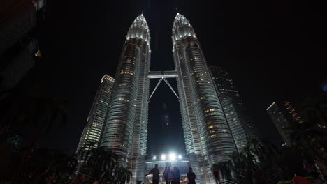 Time-lapse-view-of-Petronas-Twin-Towers-at-night-from-ground-with-people-Kuala-Lumpur-Malaysia