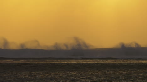 Slow-motion-view-of-ocean-waves-against-yellow-red-sunset-sky-Mauritius-Island