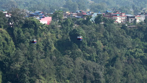 A-cable-car-crossing-a-deep-gorge-covered-with-trees-in-Kushma,-Nepal