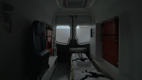 Internal-view-of-a-modern-ambulance-car-riding-on-the-street-Interior-modern-special-equipment-seat-and-stretcher