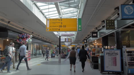 People-in-the-airport-hall-with-stores-Amsterdam