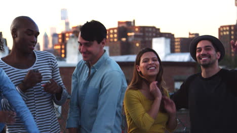 Friends-dancing-together-at-a-party-on-a-rooftop